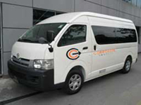 Corporate Shuttle Toyota HiAce commuter bus parked outside a depot